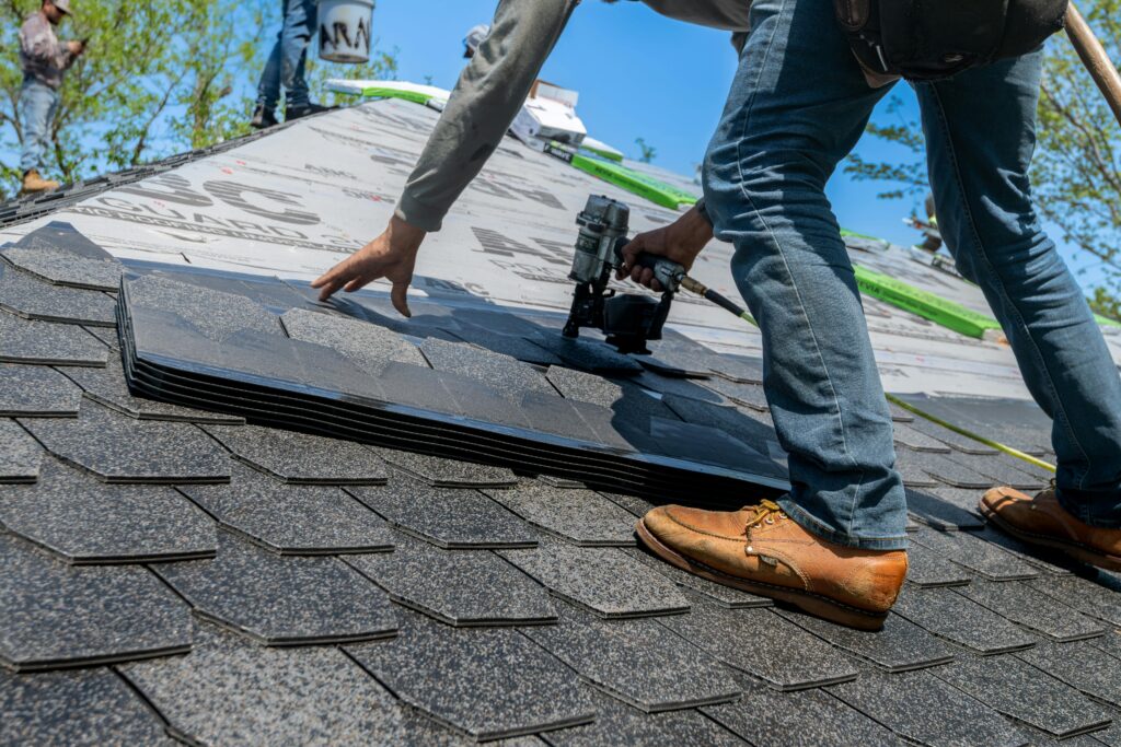 pexels photo 33404248 33404248 Roofer using nail gun for shingle installation on residential roof.